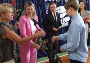 Wychowawca wręcza świadectwo uczniowi.